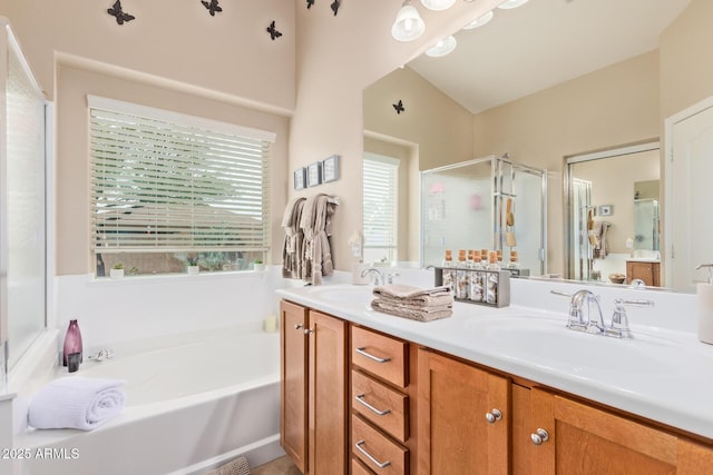 bathroom with vanity and shower with separate bathtub