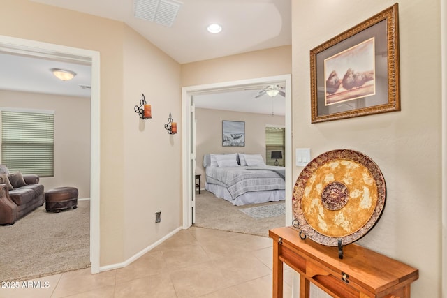 corridor featuring light colored carpet