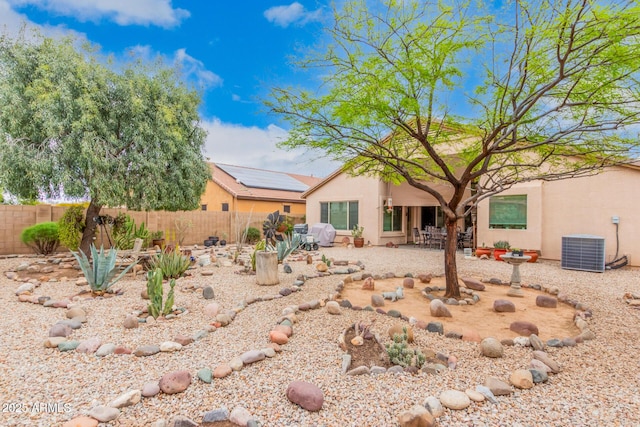 back of property with central AC unit and a patio area