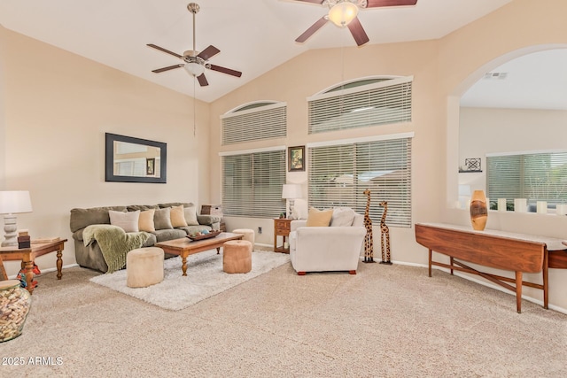 living room featuring ceiling fan, high vaulted ceiling, and light carpet