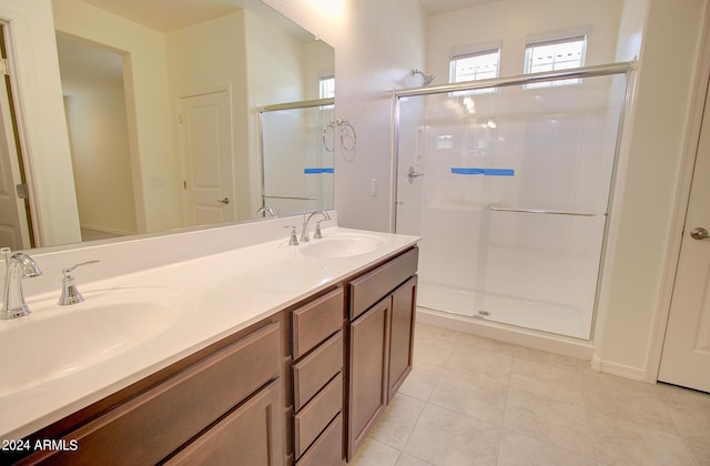 bathroom with tile patterned flooring, an enclosed shower, and vanity