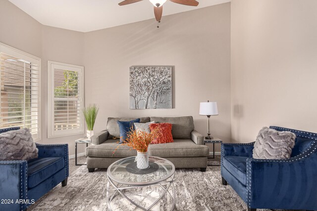 carpeted living room with ceiling fan