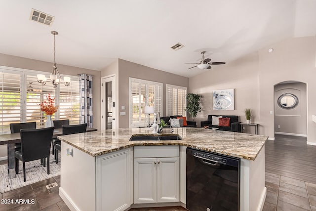 kitchen with sink, dishwasher, vaulted ceiling, white cabinets, and dark wood-type flooring