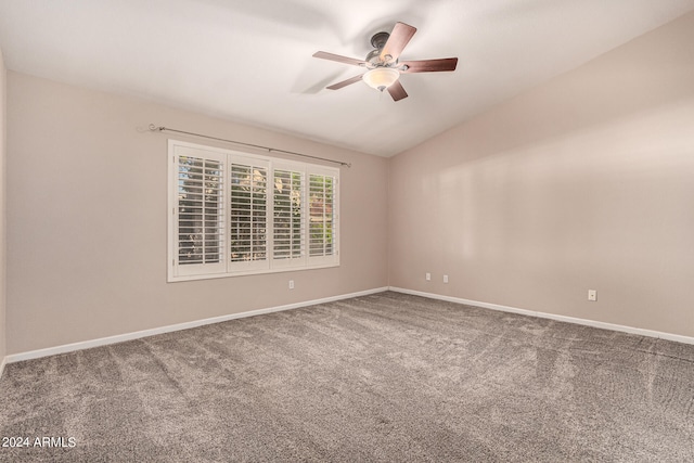 carpeted empty room featuring ceiling fan and vaulted ceiling