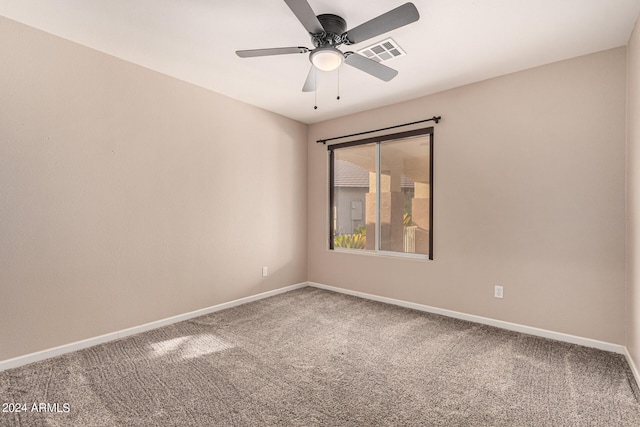 empty room with ceiling fan and carpet flooring