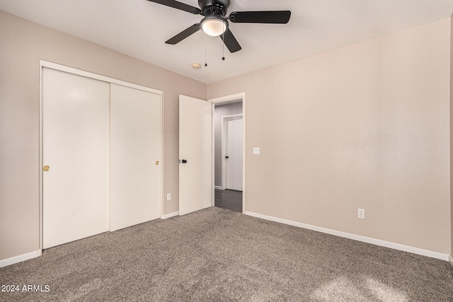 unfurnished bedroom with a closet, ceiling fan, and carpet floors