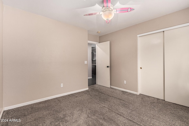 unfurnished bedroom with a closet, carpet floors, and ceiling fan