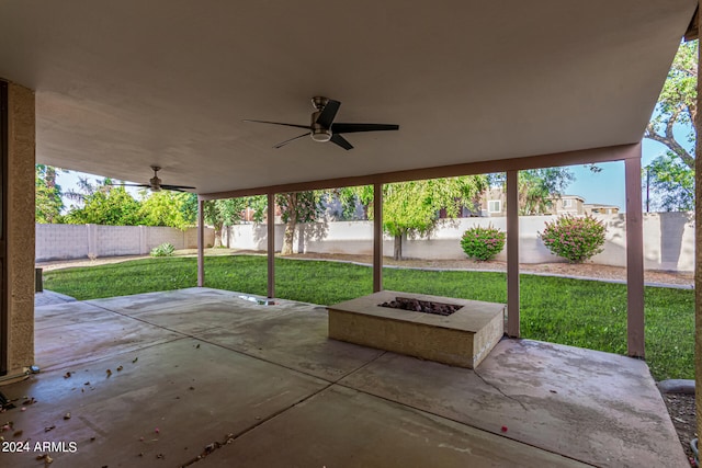 view of patio / terrace with ceiling fan and a fire pit