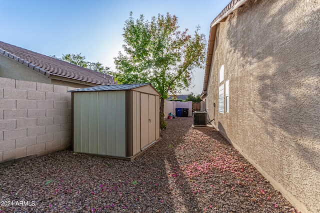 exterior space featuring a shed and central AC unit