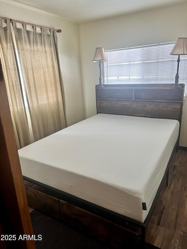 bedroom featuring wood finished floors