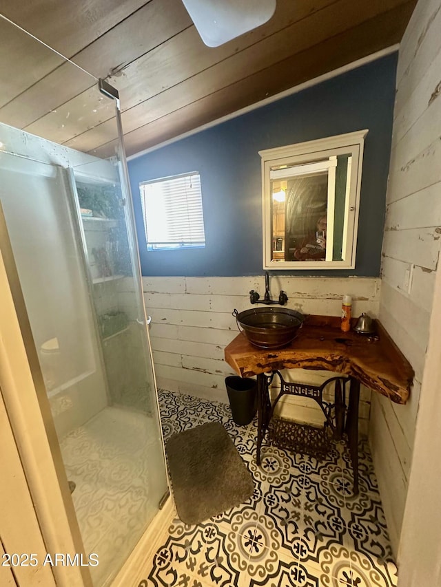 full bathroom featuring a stall shower, a sink, wooden ceiling, tile patterned flooring, and lofted ceiling