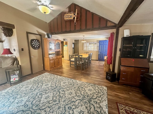 dining room featuring lofted ceiling with beams, ceiling fan, and wood finished floors