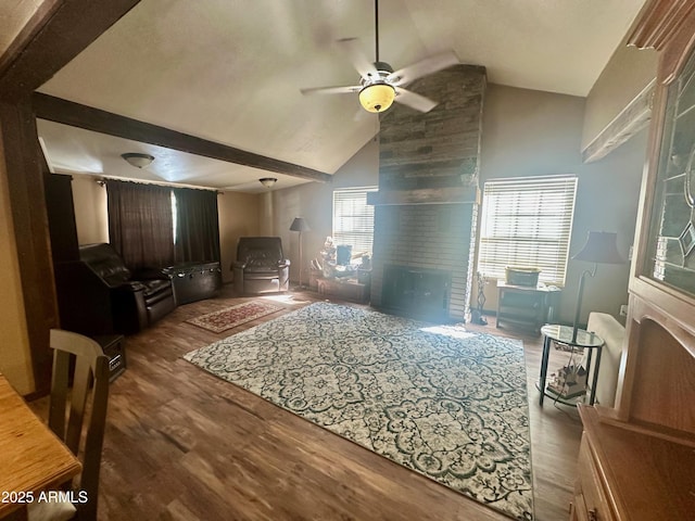 living room featuring high vaulted ceiling, a ceiling fan, and wood finished floors