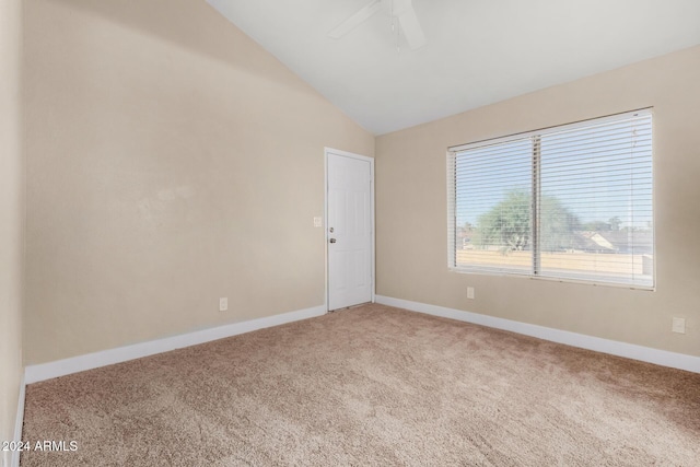 spare room featuring carpet, vaulted ceiling, and ceiling fan