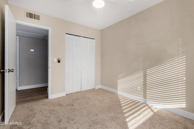 unfurnished bedroom featuring ceiling fan, a closet, and carpet