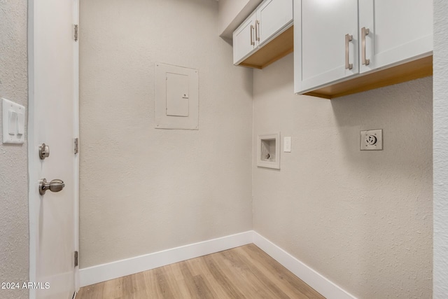 laundry area featuring washer hookup, cabinets, electric dryer hookup, electric panel, and light wood-type flooring