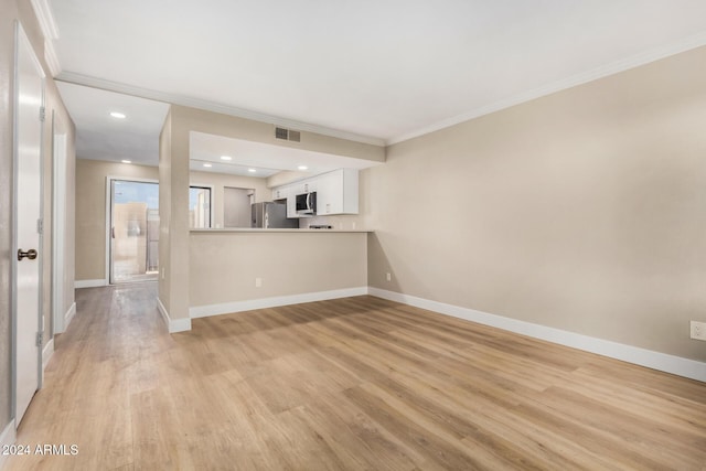 unfurnished living room with crown molding and light wood-type flooring