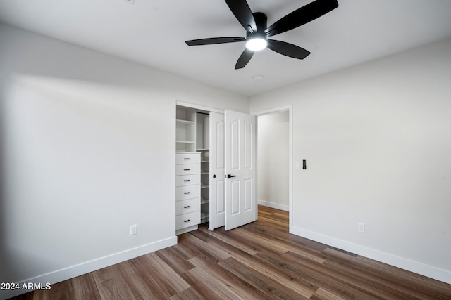 unfurnished bedroom featuring ceiling fan, wood-type flooring, and a closet