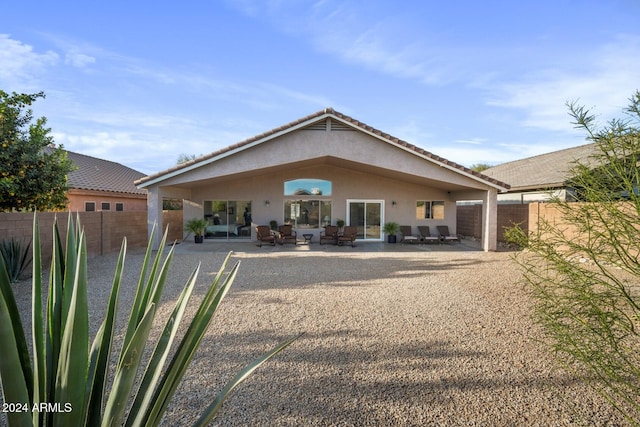 back of house with outdoor lounge area and a patio area