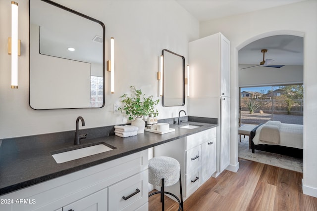 bathroom with hardwood / wood-style flooring, ceiling fan, and vanity