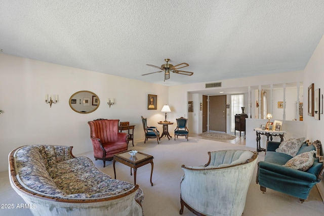 living room with light carpet, a textured ceiling, and ceiling fan