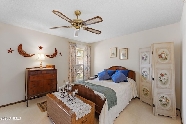 carpeted bedroom with ceiling fan and a textured ceiling