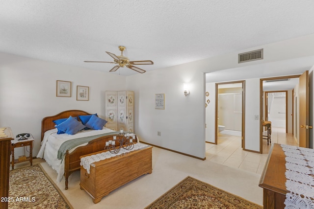 bedroom featuring ceiling fan, light colored carpet, and a textured ceiling