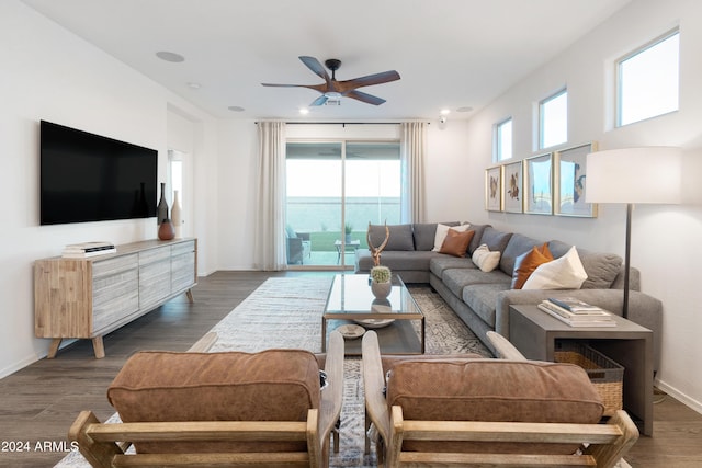 living room featuring ceiling fan and dark hardwood / wood-style flooring