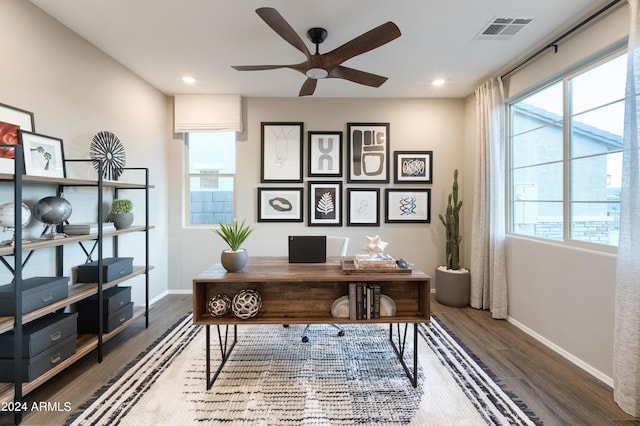 office area with a wealth of natural light, ceiling fan, and dark hardwood / wood-style flooring