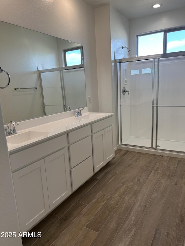 bathroom with a wealth of natural light, vanity, and an enclosed shower