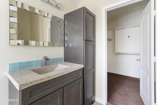 bathroom with vanity and baseboards