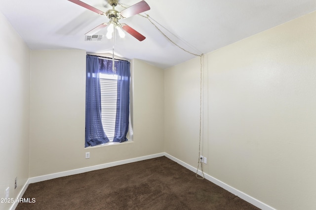 empty room featuring baseboards, visible vents, lofted ceiling, ceiling fan, and dark carpet