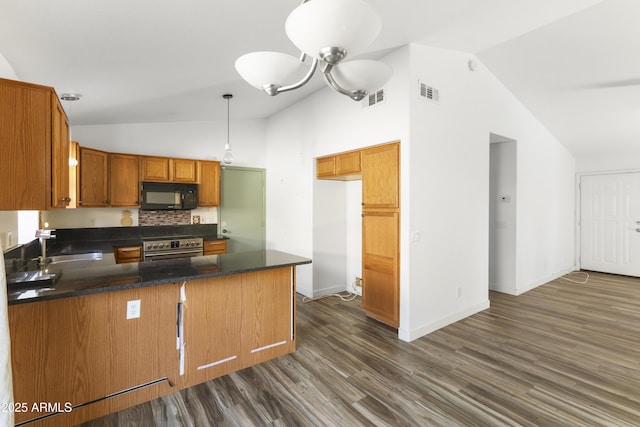 kitchen with dark countertops, visible vents, black microwave, a peninsula, and stainless steel electric range