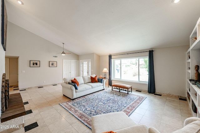 living area featuring high vaulted ceiling, light tile patterned floors, visible vents, and a ceiling fan