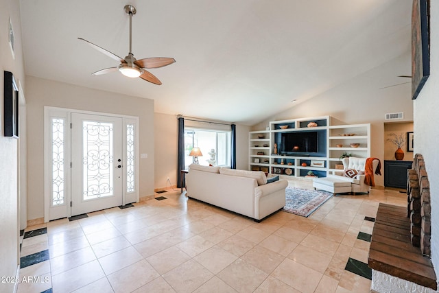 living room featuring light tile patterned floors, visible vents, a ceiling fan, vaulted ceiling, and built in shelves