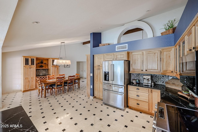 kitchen featuring vaulted ceiling with beams, light brown cabinetry, high quality fridge, and dark countertops