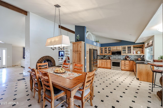 dining space with high vaulted ceiling and a wealth of natural light