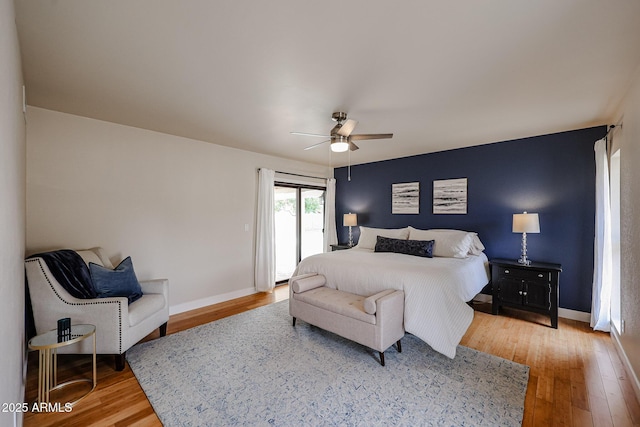 bedroom with baseboards, ceiling fan, light wood-style flooring, and access to exterior