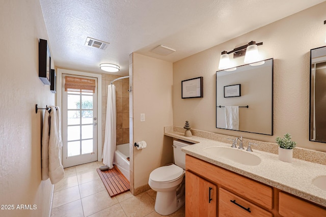 full bathroom featuring double vanity, visible vents, toilet, a textured ceiling, and a sink