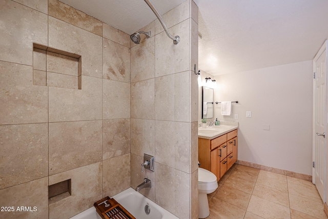 bathroom featuring baseboards, bathing tub / shower combination, toilet, tile patterned floors, and vanity