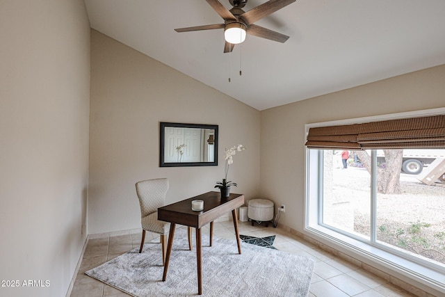 office space with baseboards, vaulted ceiling, a ceiling fan, and light tile patterned flooring