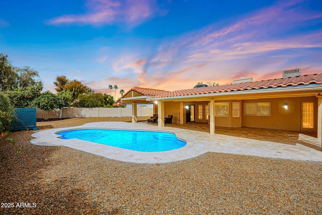 view of swimming pool with a fenced in pool, a fenced backyard, and a patio