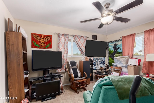 interior space featuring a ceiling fan and carpet