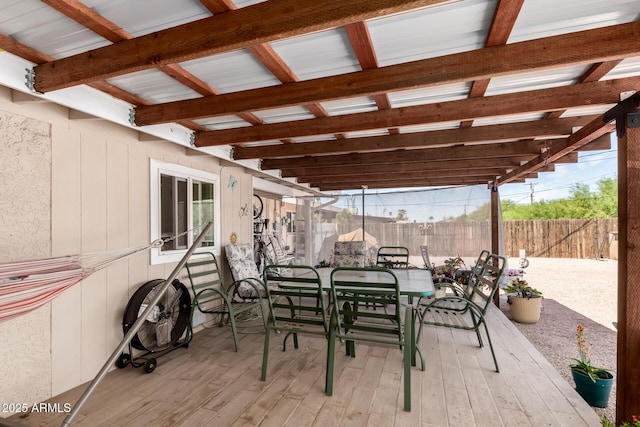 view of patio / terrace with a fenced backyard, a wooden deck, and outdoor dining space