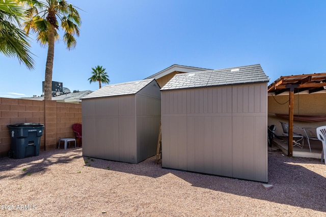 view of shed with fence