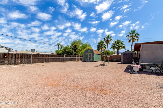 view of yard featuring a fenced backyard, an outdoor structure, and a shed