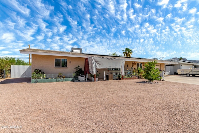 view of front of home featuring fence, driveway, and a gate