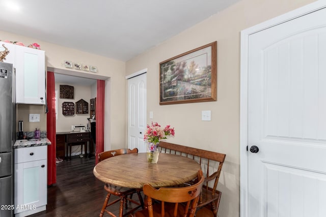 dining area featuring dark wood-style flooring