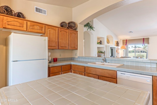 15371 W Piccadilly Rd, Goodyear, AZ 85395 - kitchen featuring visible vents, tile counters, a sink, and white appliances