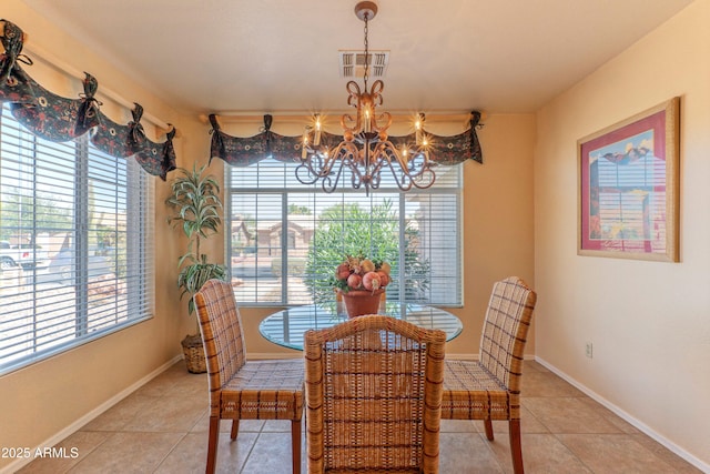 15371 W Piccadilly Rd, Goodyear, AZ 85395 - dining space featuring light tile patterned floors, an inviting chandelier, visible vents, and plenty of natural light